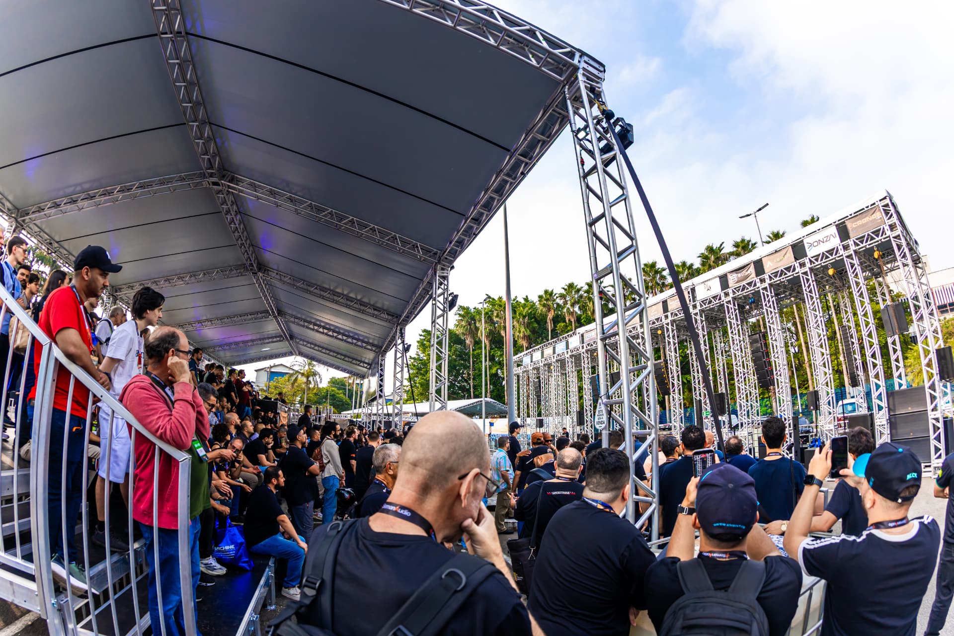 Público acompanhando demonstração sob palco coberto montado pela Plantar Eventos